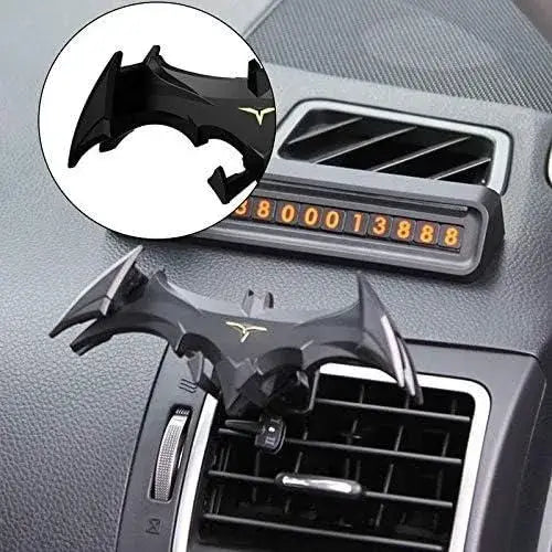 Black car phone holder shaped like a bat on a car dashboard with a close-up inset.