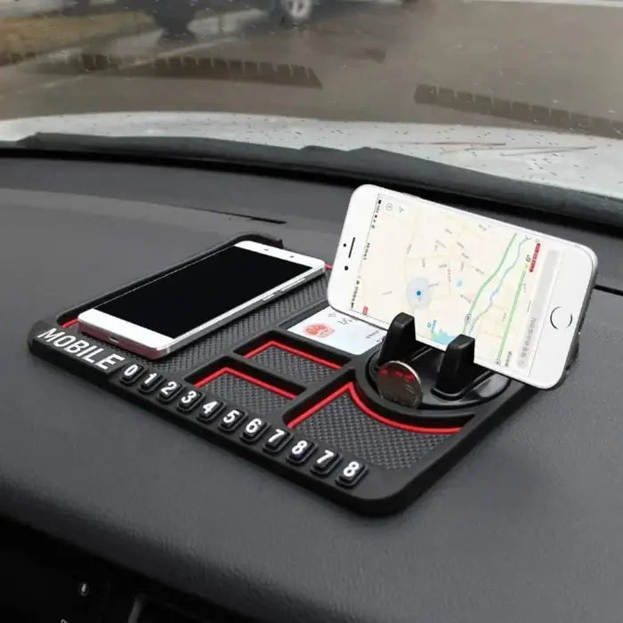 Car dashboard with a phone holder and two smartphones on a road background