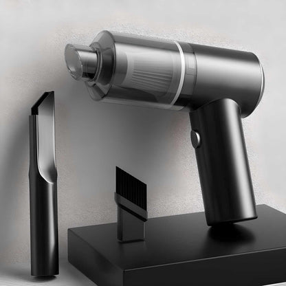 Silver handheld vacuum cleaner with attachments on a gray background