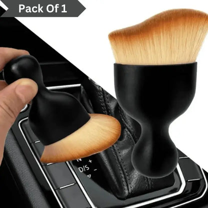 Makeup brush with black handle and wooden bristles on a car gear shift.