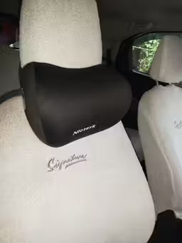 Car headrest cover with 'Nokian' branding in a vehicle interior.