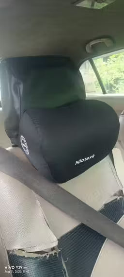 Car headrest cover with 'Nipeter' branding in a vehicle interior.