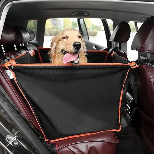 Dog sitting in a car with a black pet car seat having a barrier between the front and back seats.