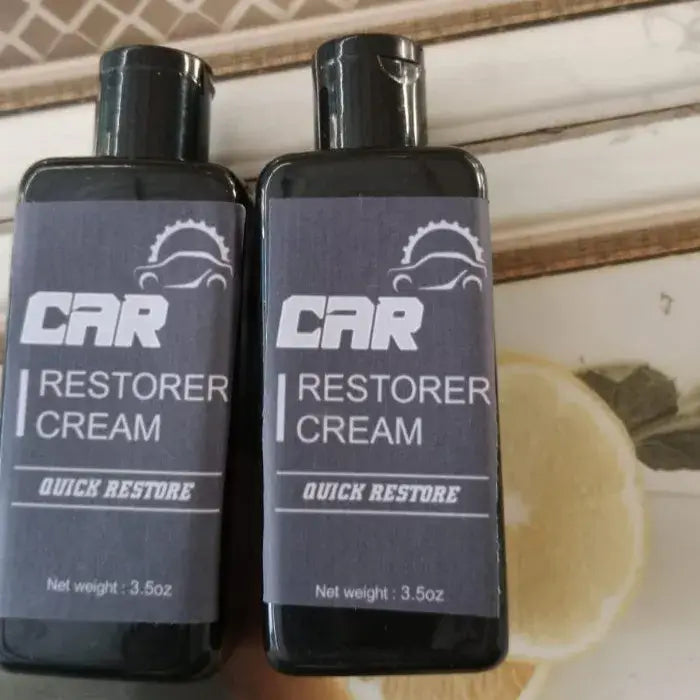 Two bottles of Car Restorer Cream on a surface with a blurred background