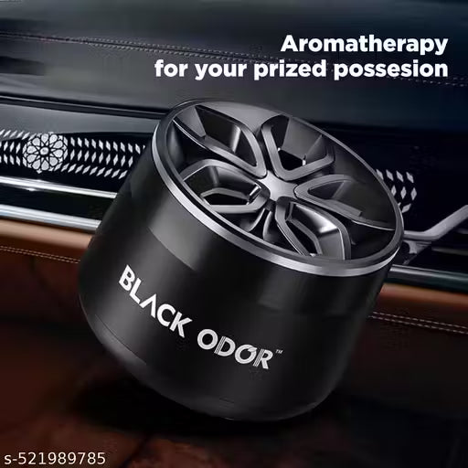 Black Odor car air freshener in front of a car's interior.